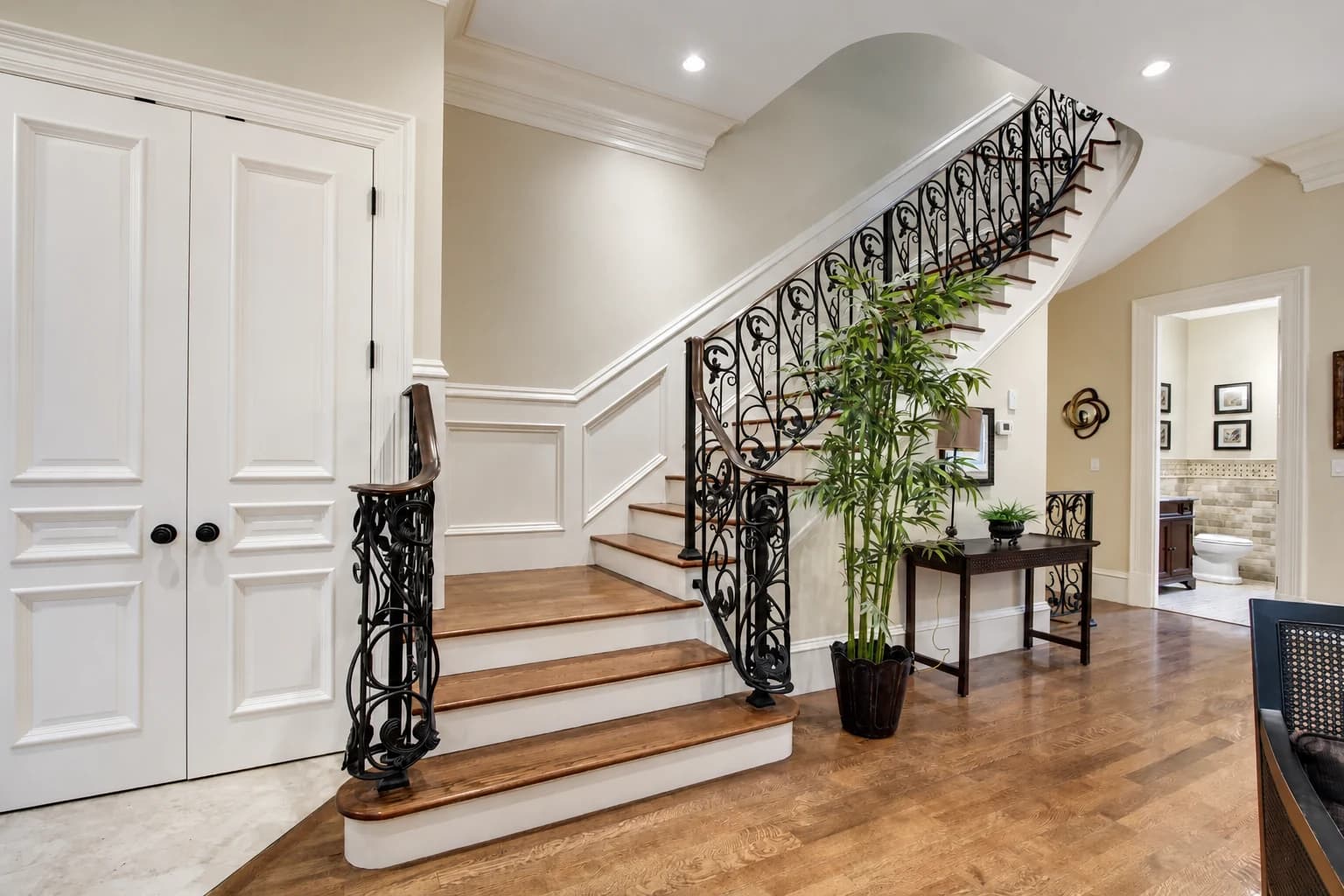 Renovated interior with curved stair and iron balustrade