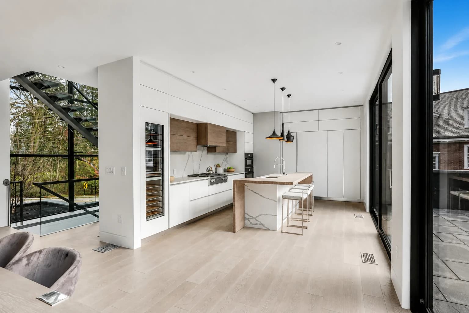 Minimal white kitchen with full-height glazing